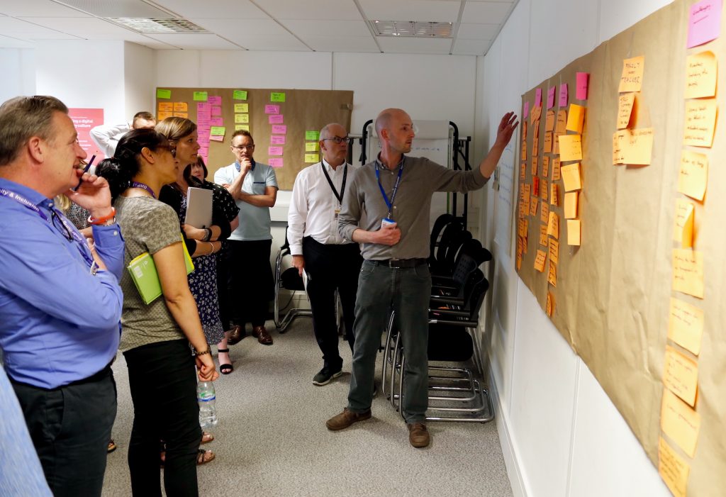 Ben Holliday (far right) leads discussion during the design sprint