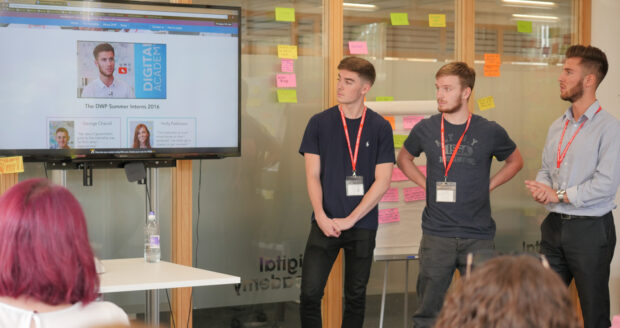 Lewis (right) and the other interns show the video they created as part of their internship programme