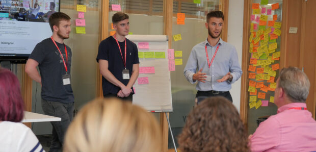 Lewis (right) delivers a presentation during his internship