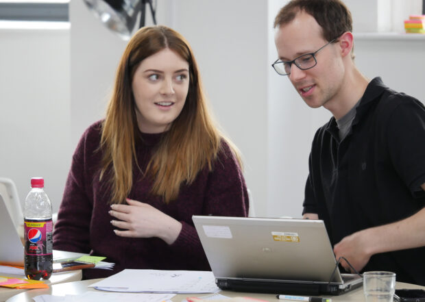 Jessica and a colleague discuss a prototype at GovJam