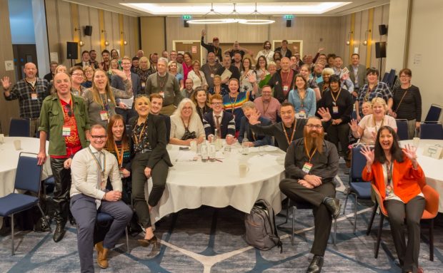 Delegates at the event take part in a group photograph