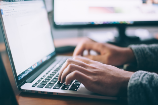 Person typing on a computer keyboard