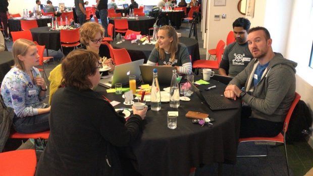 Attendees around a table working together