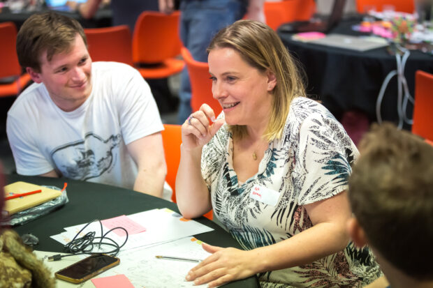 Kate Norman sitting at a table with her hack team