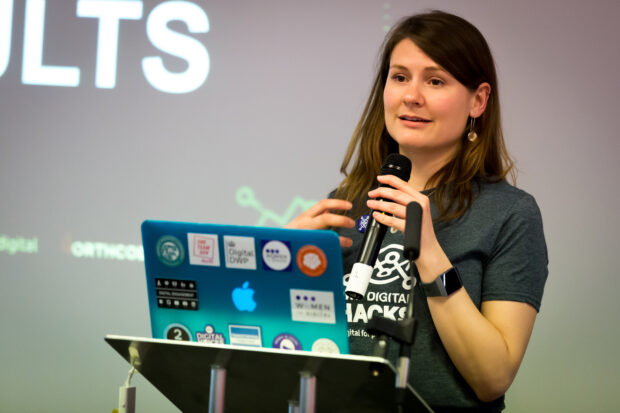 Calei Smith standing at a lectern at the hack