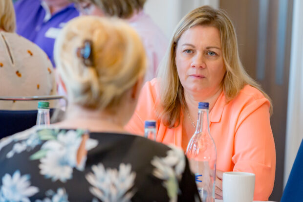 Liz talking to a colleague at an event