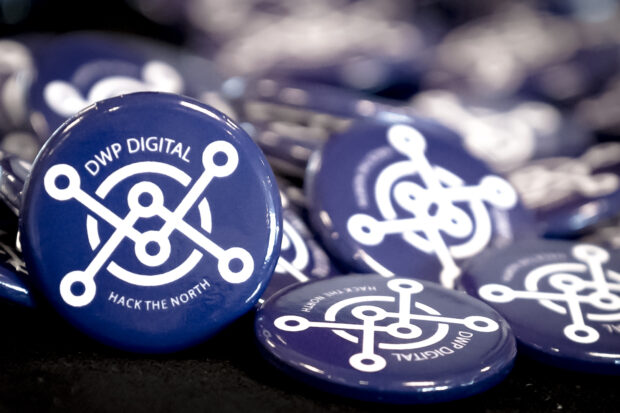 A number of Hack The North pin badges on a table