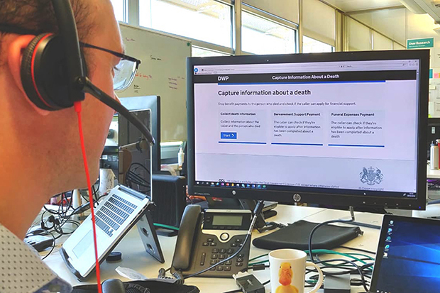 A DWP colleague using the Capture information about a death service, looks at a computer screen