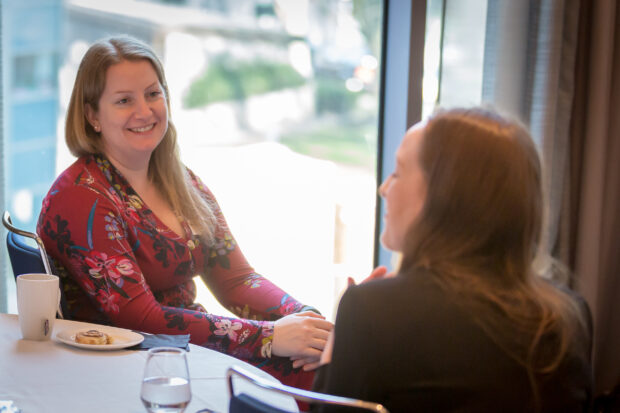 Hazel chatting at a table with a fellow Digital Voice