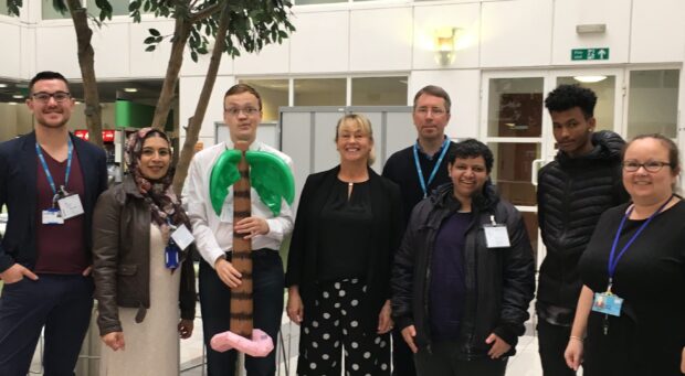 Group of attendees with Carolynn and the inflatable palm tree from the interactive introductions session.