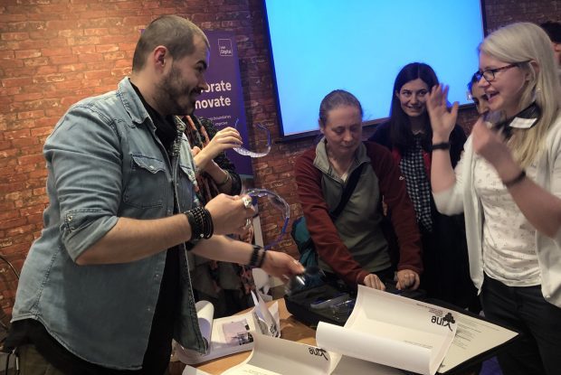 DWP's Craig Abbott at an event demonstrating accessibility products to a crowd of 3 women