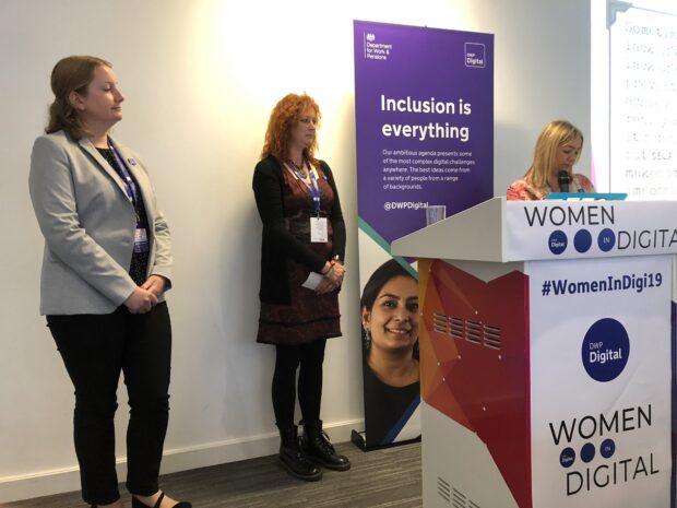 Three women from the digital voices programme presenting at a lectern