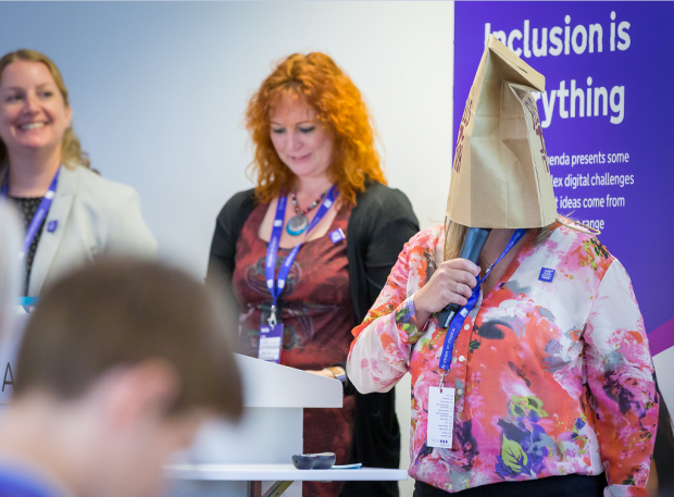 Digital voices Hazel, Lin and Liz presenting. Liz has put a paper bag over her head.