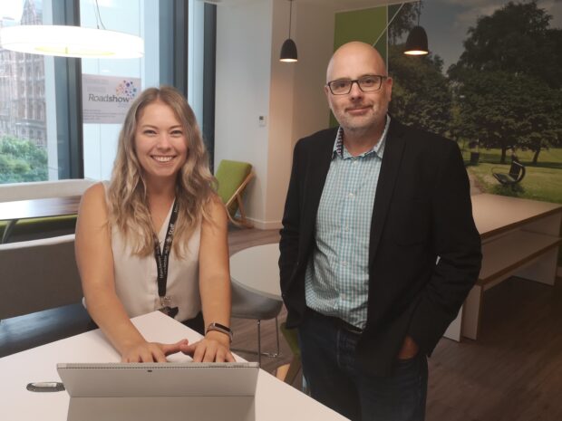 Melissa and Karl in the office with a laptop computer