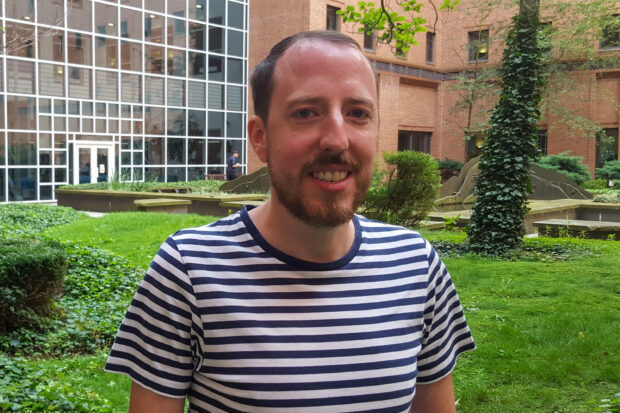 Mikey Cattell standing in the garden area of DWP Digital's Leeds Digital Hub