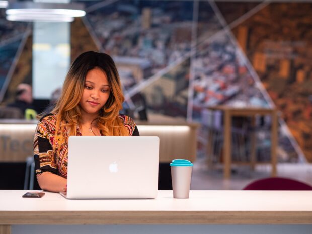 Fey working at her laptop