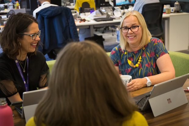 Tracey networking with 2 other colleagues