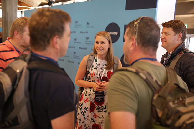 Aleks Bobrowska networking with four other colleagues at Sprint 19 