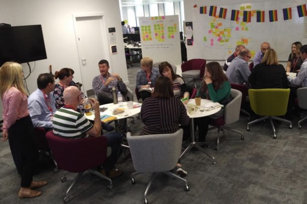 Jude Eccles leads a workshop with 14 colleagues around two tables