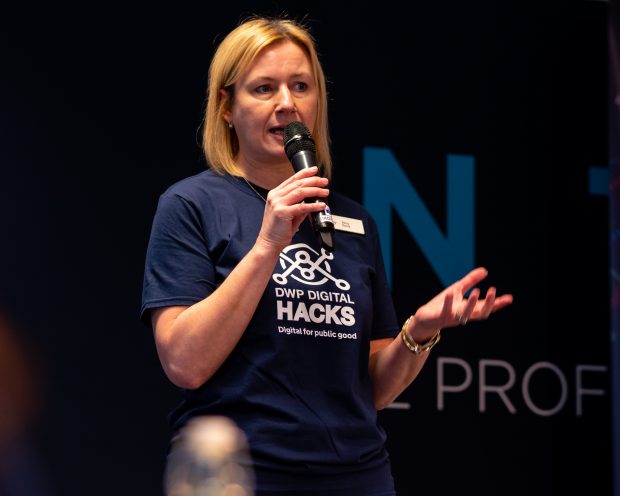 Image shows Amy Pond in a hack t shirt speaking into a microphone