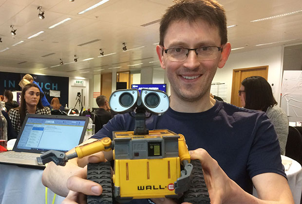 Andy tyack with his team mascot a Wall-E toy