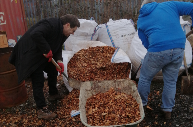 Andrew and a colleague shovelling wood chip for the new paths