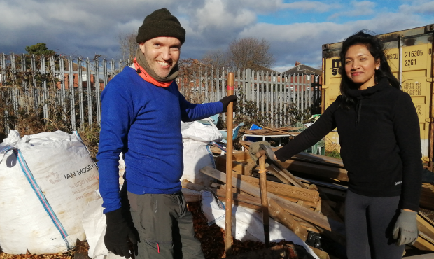 Image of Oliver and colleague Damine holding shovels