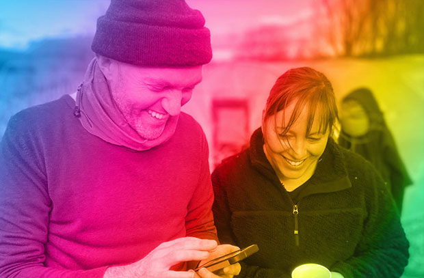 Oliver and Rachel talking together, photo has a rainbow filter overlaid