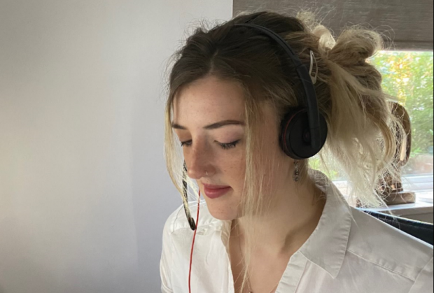 portrait photo of apprentice Lizy working wearing a headset