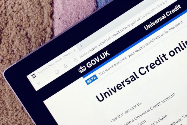 Universal Credit application page of the gov.uk website shown on a coloured carpet
