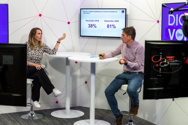 Lisa Mason and Andrew Ellis from DWP's Digital Engagement Team lead a session during the Digital Voices learning event sat at a table in front of a monitor, surrounded by cameras