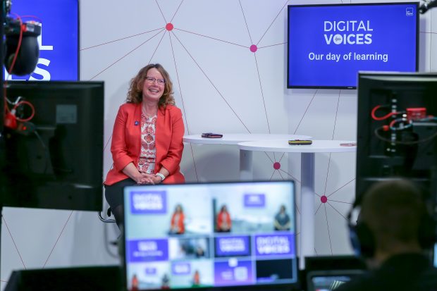 Digital Voices programme lead Joanne Rewcastle is shown presenting in front of television cameras and monitors