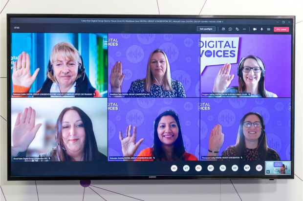 Six women are shown on a computer screen raising their hands