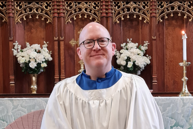 Mark Young in his choir robes in his Church