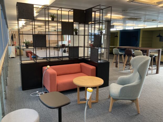 A seating area in the Newcastle test and learn hub space with various chair options and large shelving