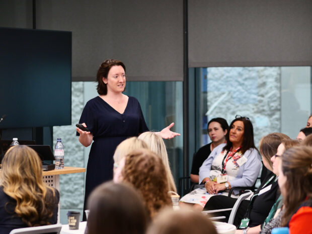 A colleague presenting to a room of colleagues. 