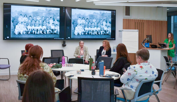 Marlene sat speaking to attendees