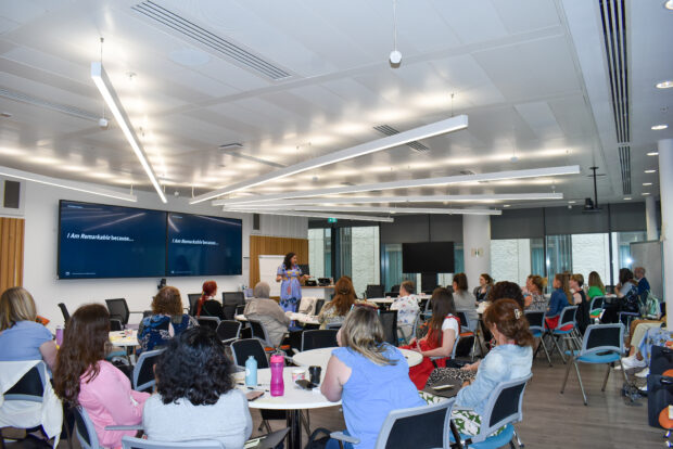 Soraya delivering a presentation to a room of attendees